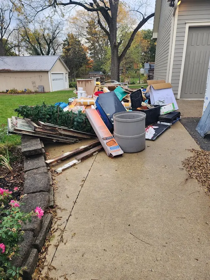 Dumpster being loaded with debris for Estate Cleanout Dumpster Rental in Emerald Lake Hills